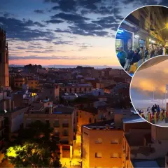 Wieczorna panorama miasta z wieżą kościelną i widokiem na plażę. Ludzie spacerują po ulicach i nad morzem, co sugeruje, że w Barcelonie jest bezpiecznie.